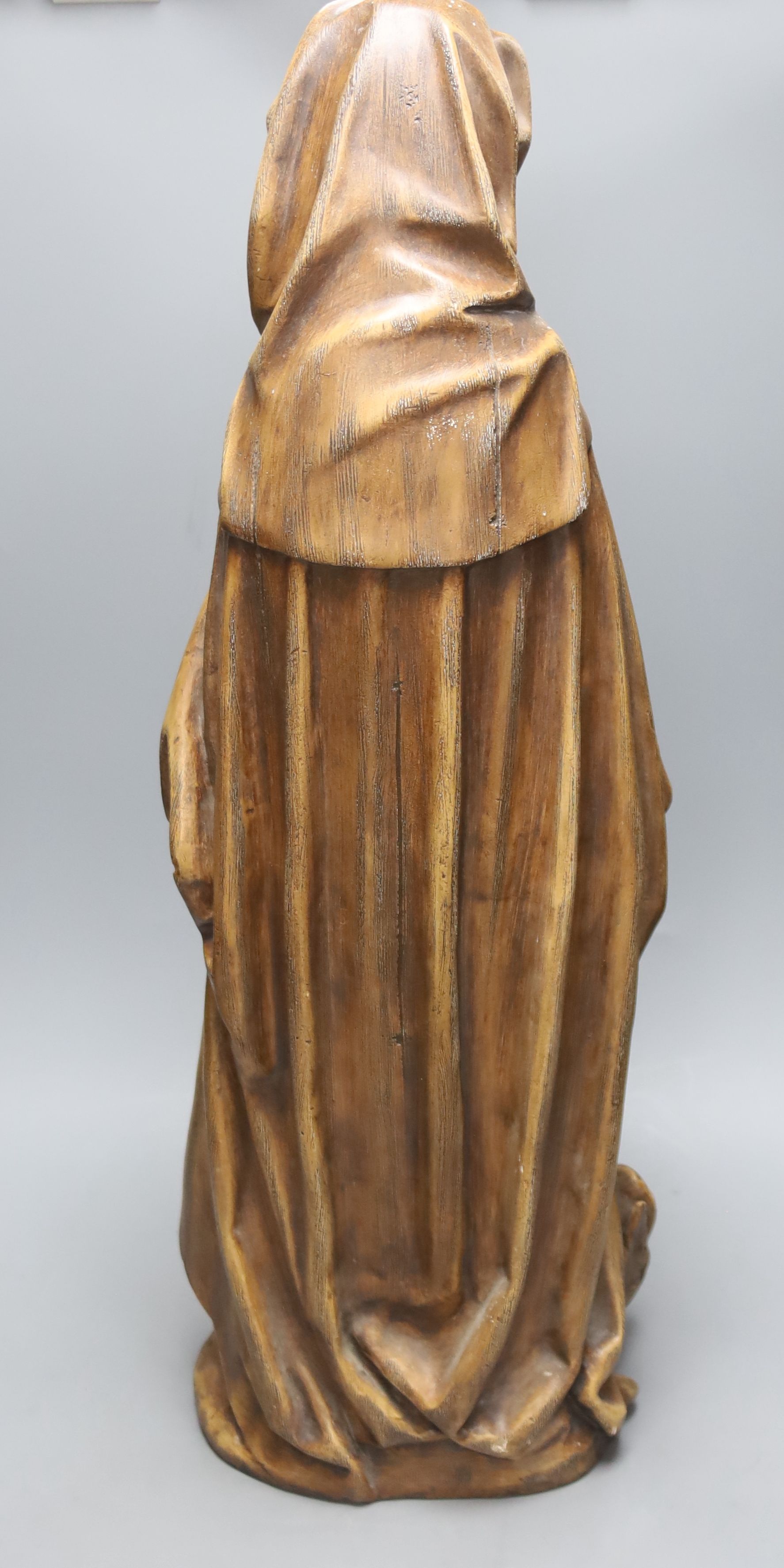 A large painted plaster statue of St Martha, height 70cm